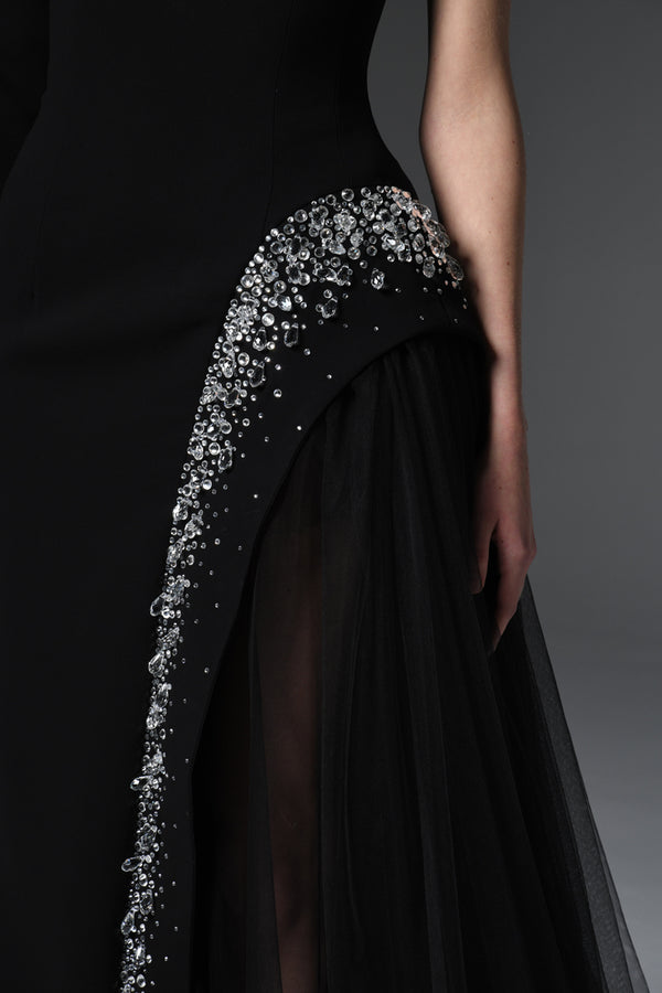 Black asymmetric crêpe dress with crystal embroidery and tulle on the side slit