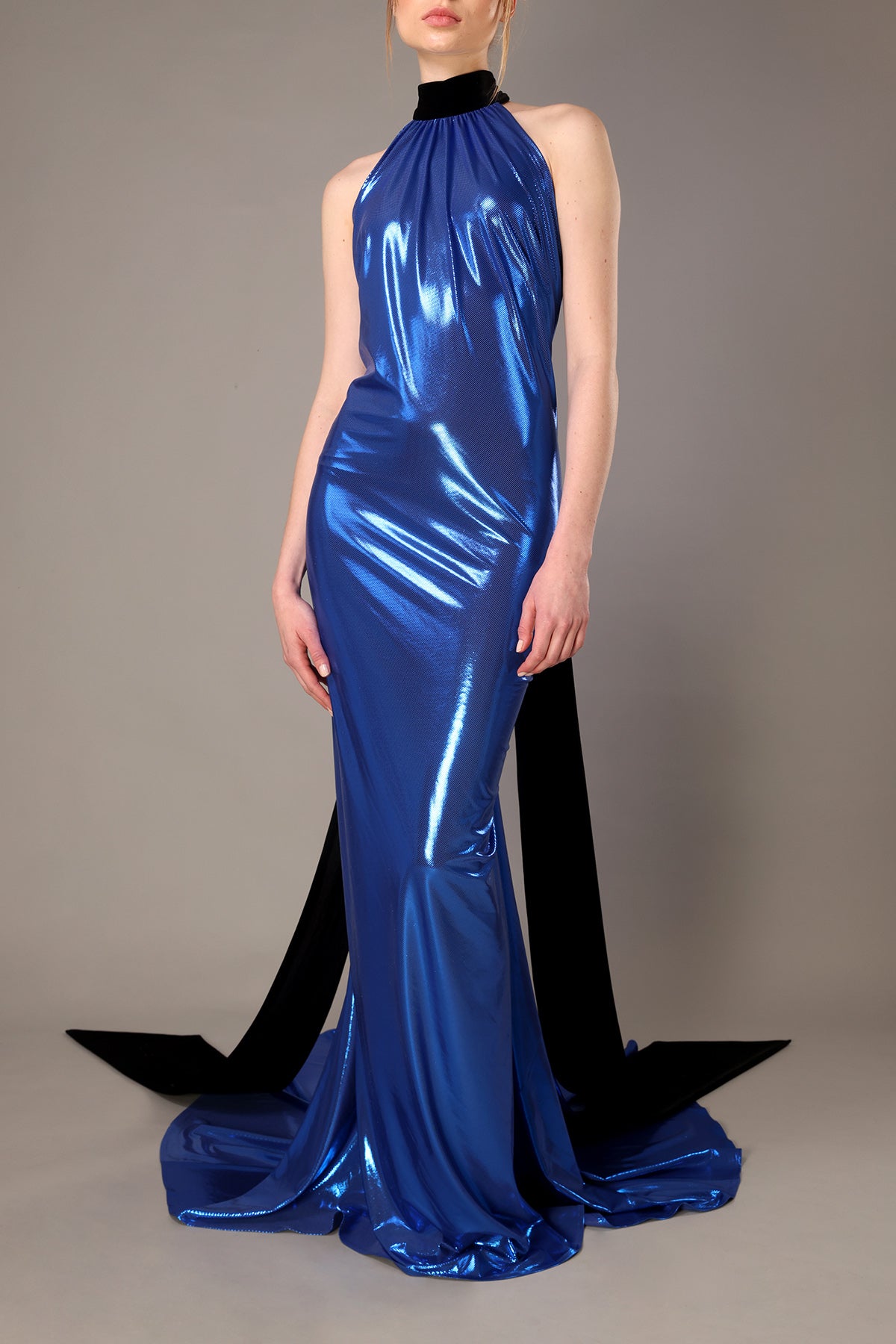 High necked backless blue lamé dress with black velvet tie