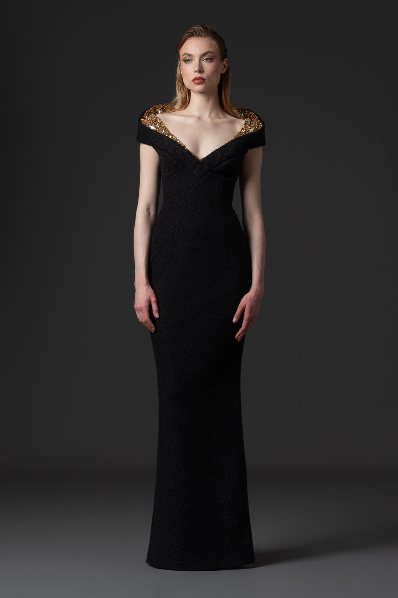 A bouclé gown with a V neckline and a structured beaded collar