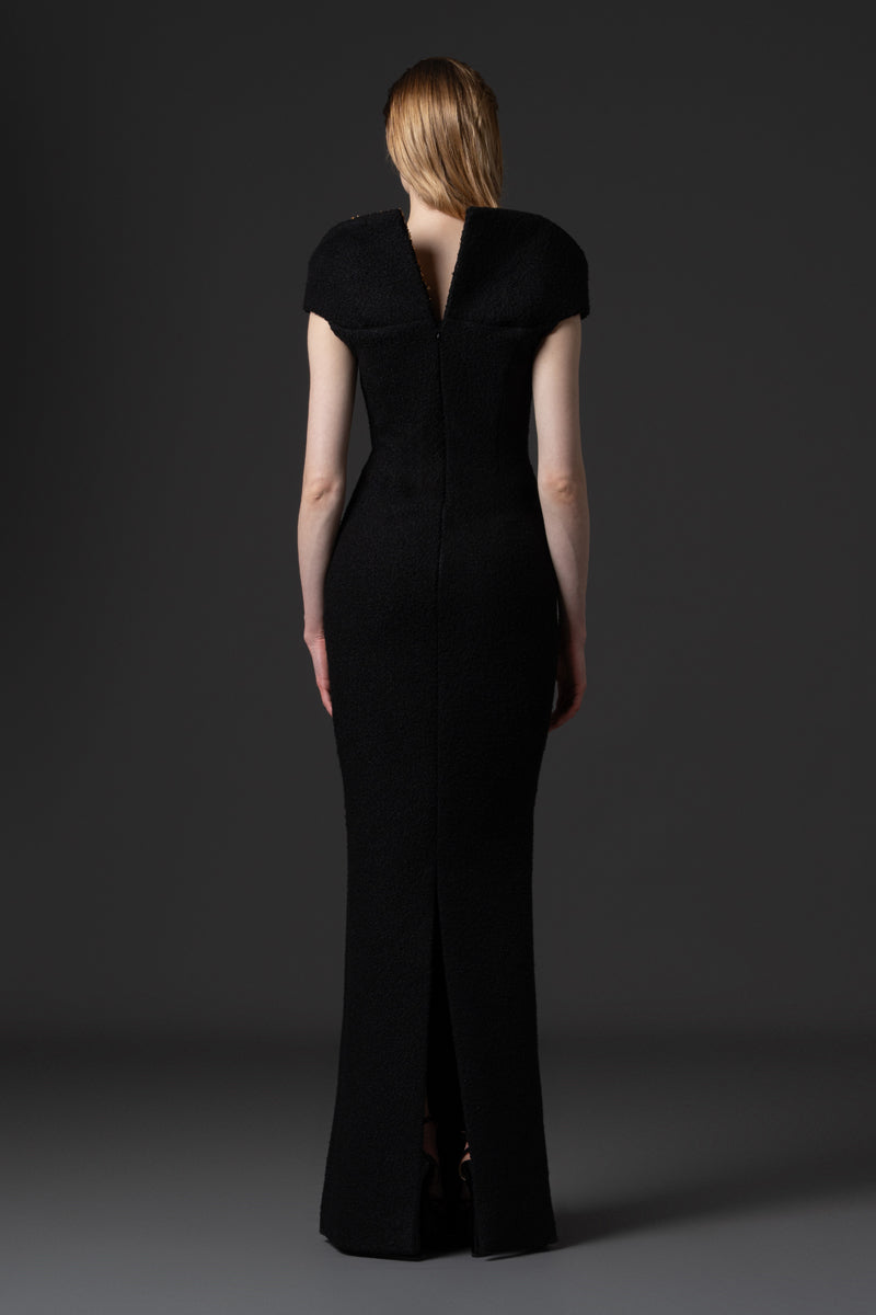 A bouclé gown with a V neckline and a structured beaded collar