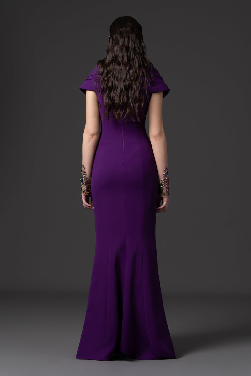 A crêpe dress with an off-the-shoulder neckline and a 3D-printed embroidery
on the bodice and sleeves