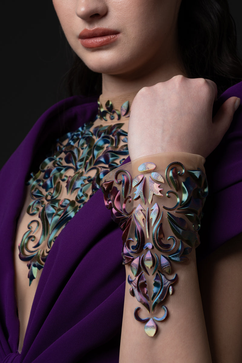 A crêpe dress with an off-the-shoulder neckline and a 3D-printed embroidery
on the bodice and sleeves