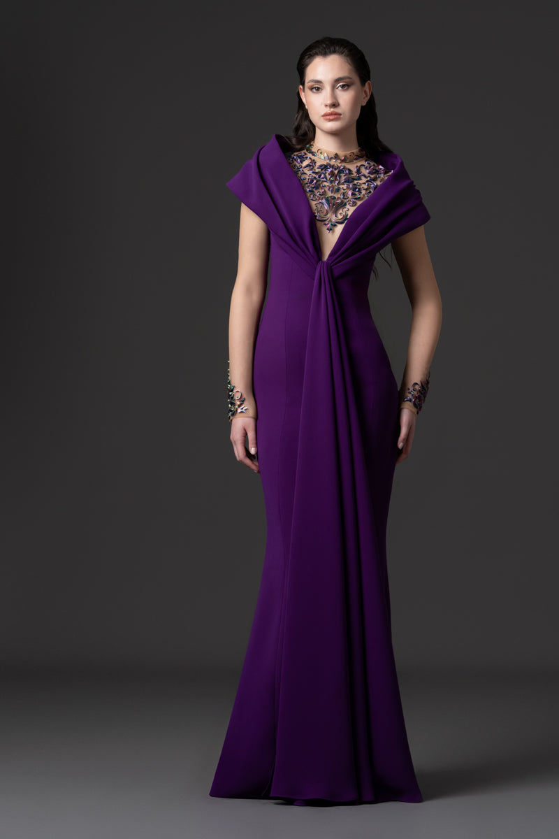 A crêpe dress with an off-the-shoulder neckline and a 3D-printed embroidery
on the bodice and sleeves