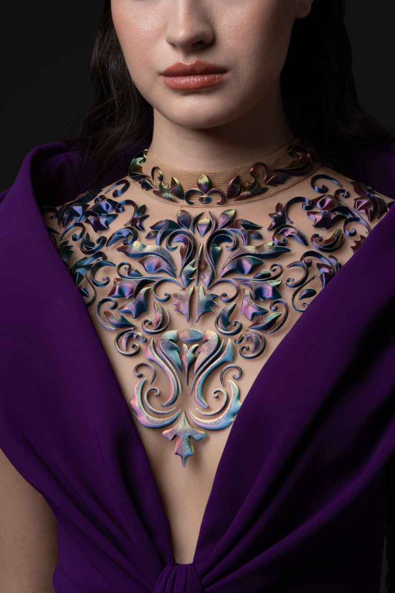 A crêpe dress with an off-the-shoulder neckline and a 3D-printed embroidery
on the bodice and sleeves