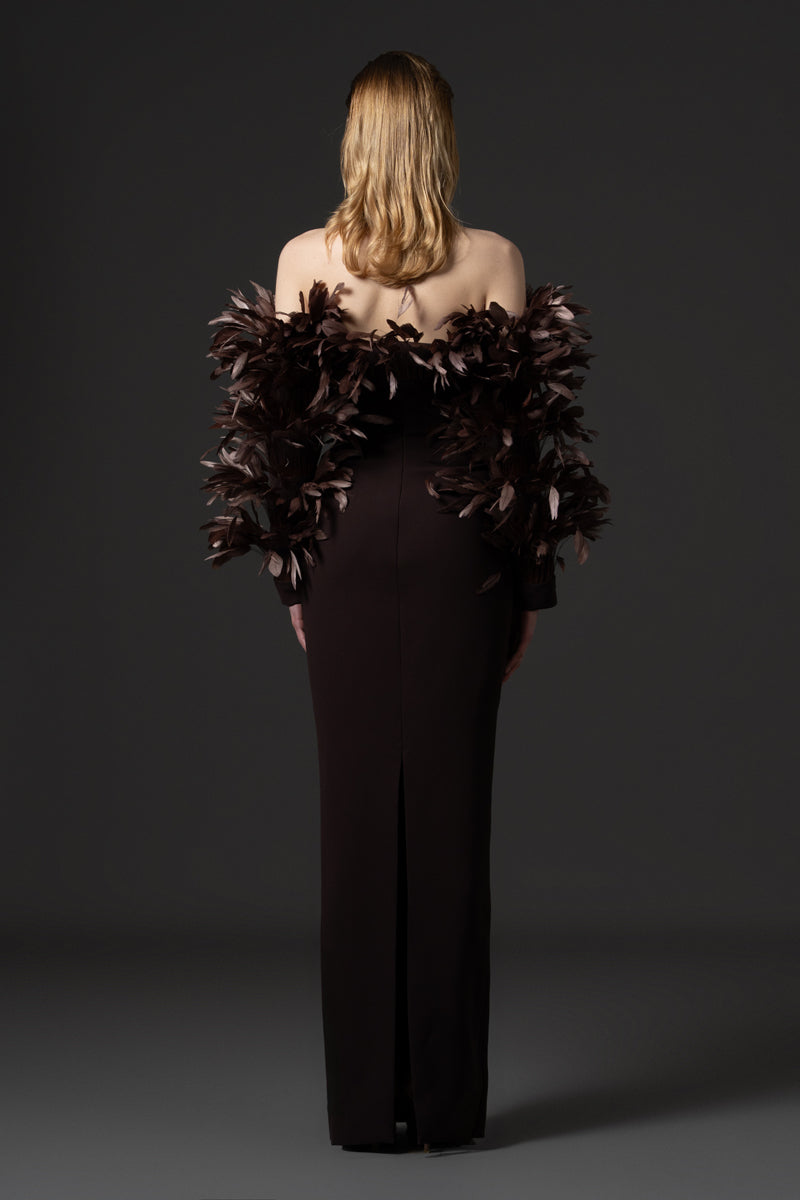 A crêpe gown with voluminous feathers on neckline and sleeves