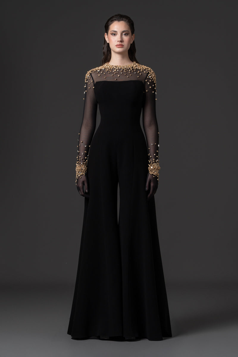 A crêpe jumpsuit with a sheer high neck tulle bodice beaded with metallic stones