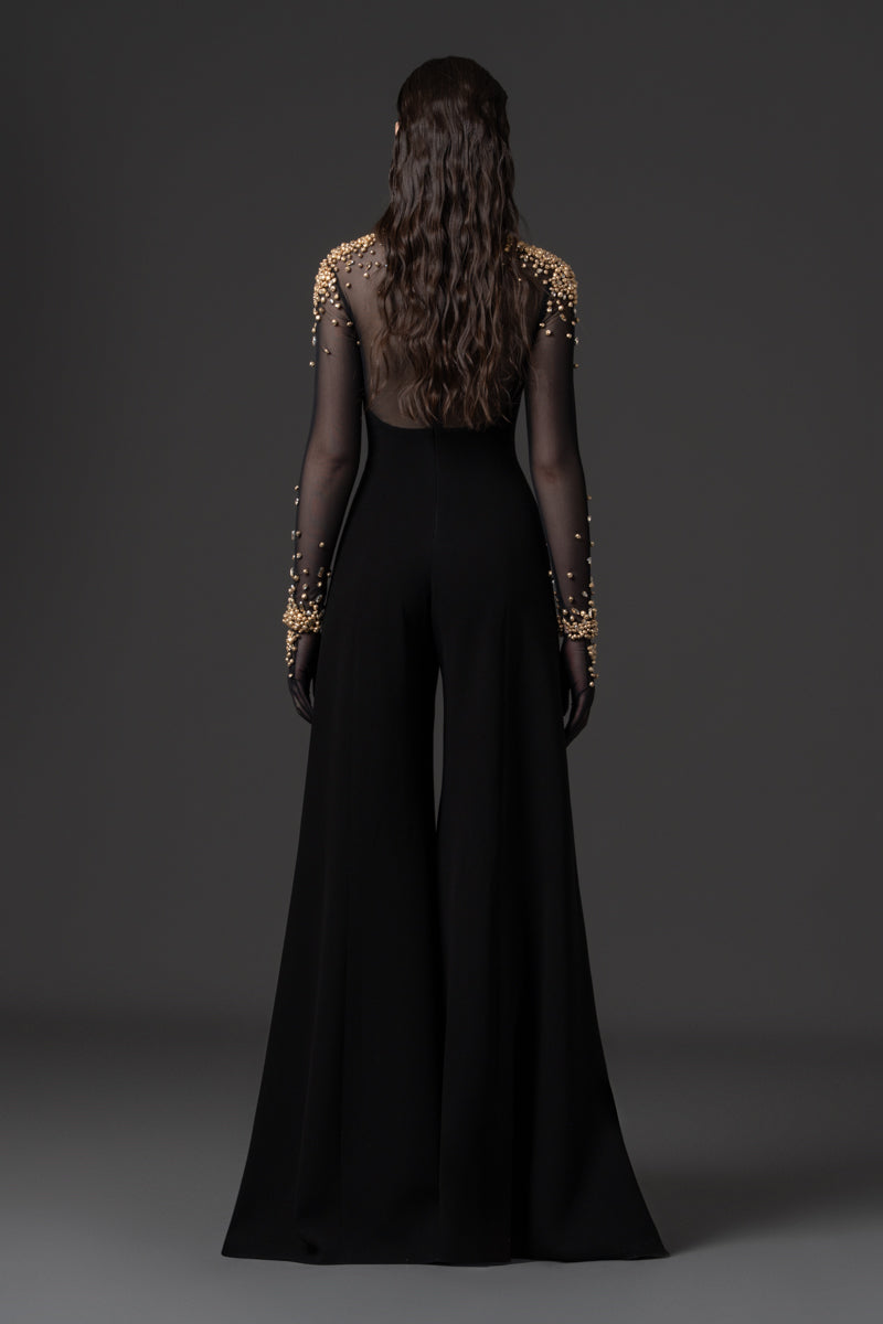 A crêpe jumpsuit with a sheer high neck tulle bodice beaded with metallic stones