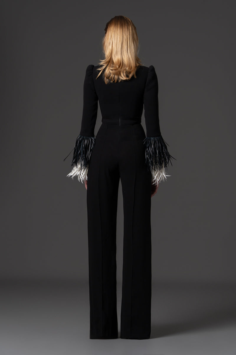A crêpe jumpsuit with a square neckline and feathered cuff details