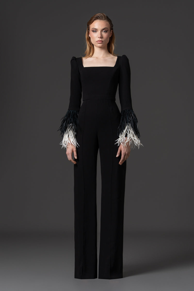 A crêpe jumpsuit with a square neckline and feathered cuff details