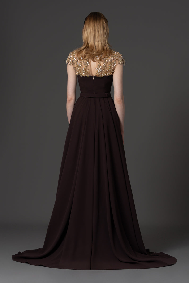 A crêpe jumpsuit with beaded neckline and a crêpe overskirt