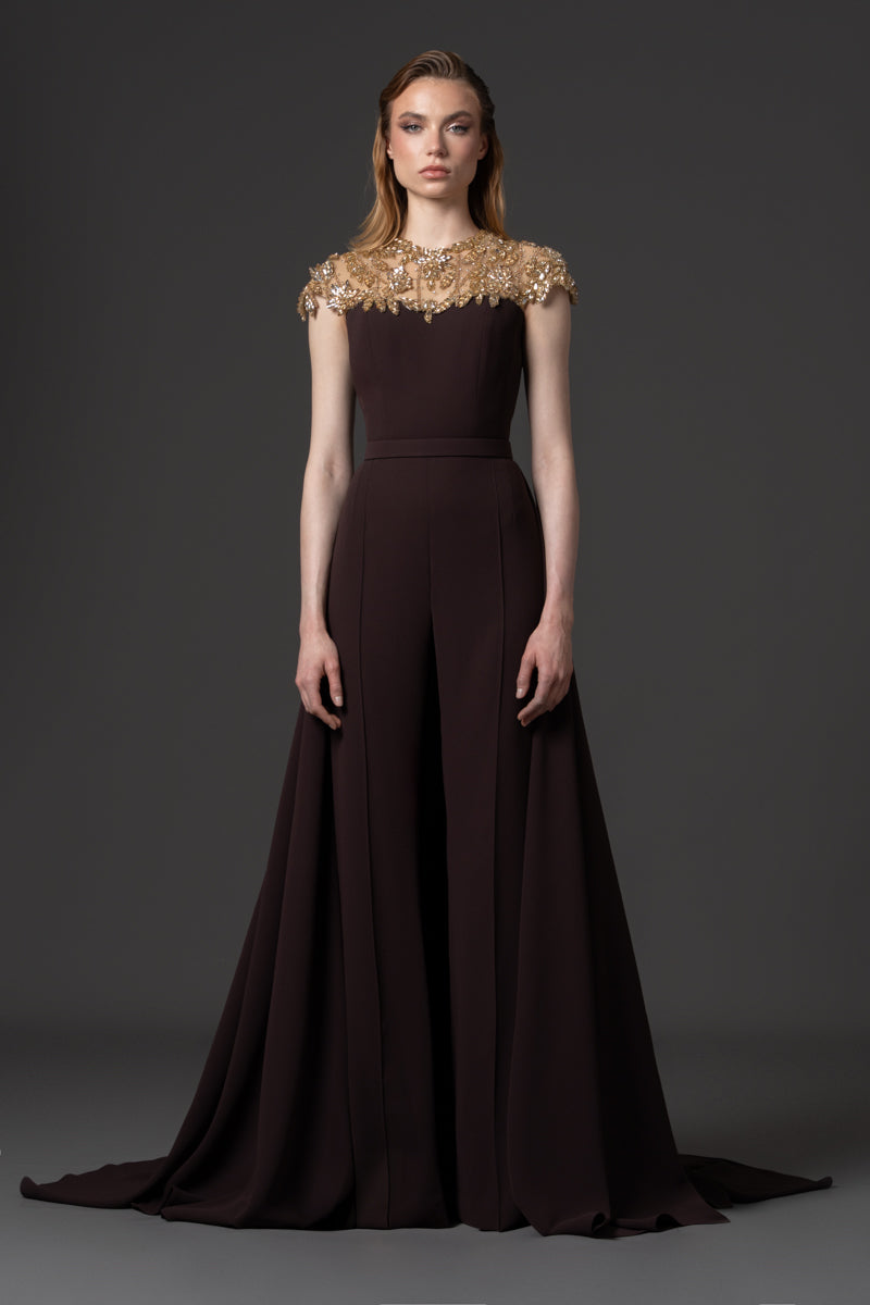 A crêpe jumpsuit with beaded neckline and a crêpe overskirt