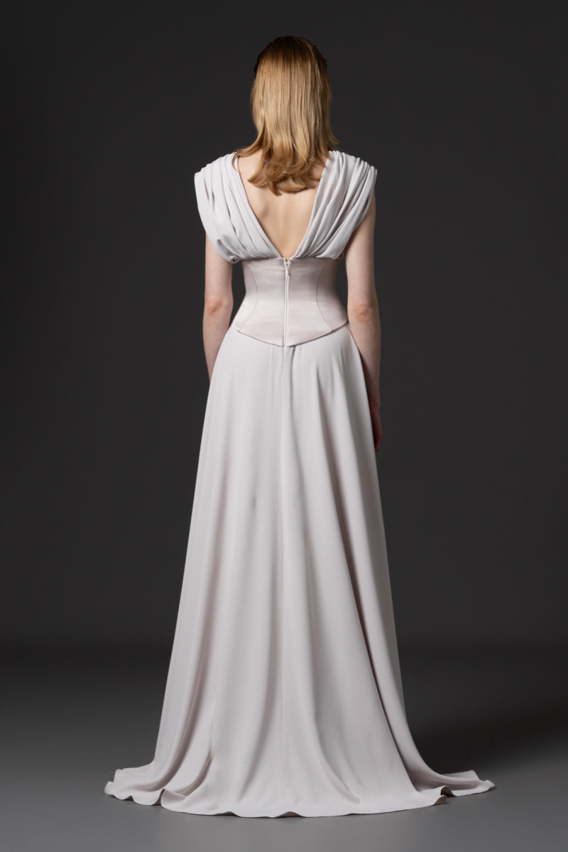 A draped gown designed with a defined beaded radzimir corset belt