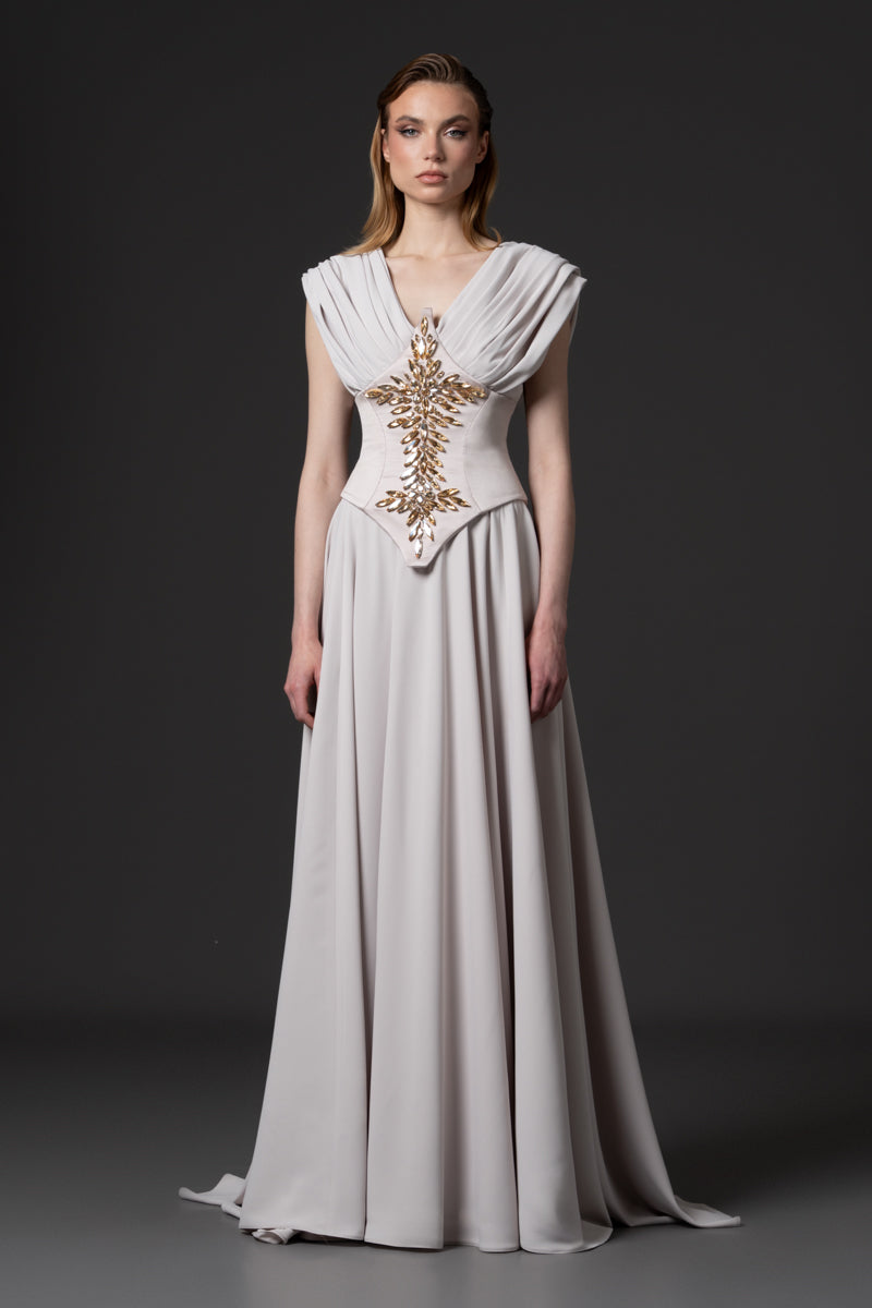 A draped gown designed with a defined beaded radzimir corset belt