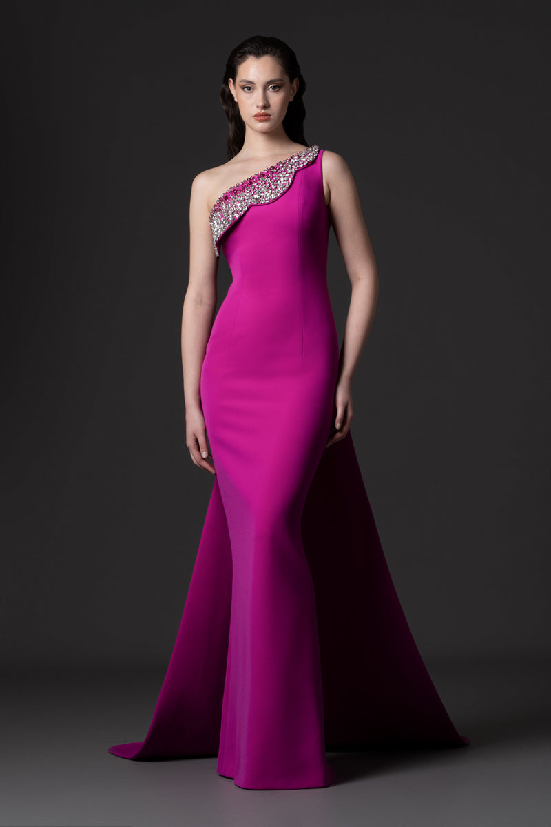 A fitted crêpe gown with an overskirt and a crystal embroidered flap detail at the neckline
