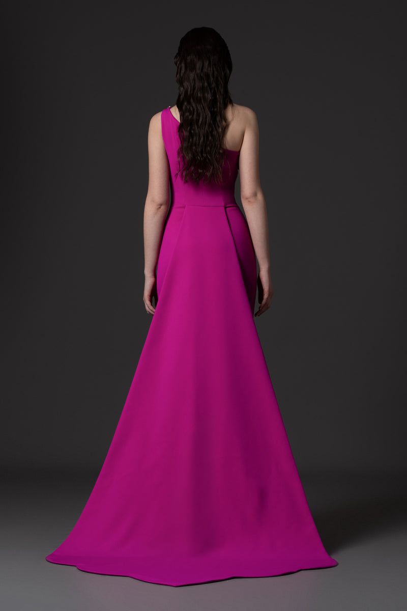 A fitted crêpe gown with an overskirt and a crystal embroidered flap detail at the neckline