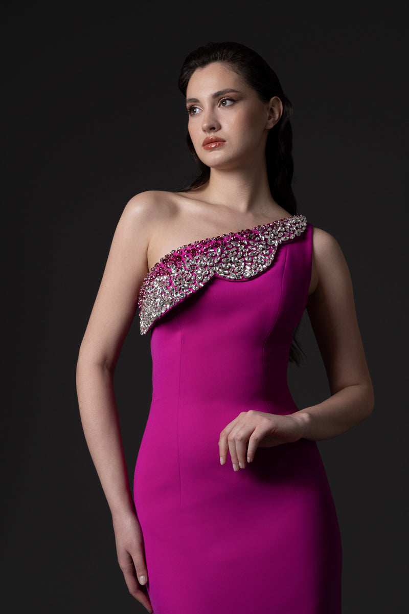 A fitted crêpe gown with an overskirt and a crystal embroidered flap detail at the neckline