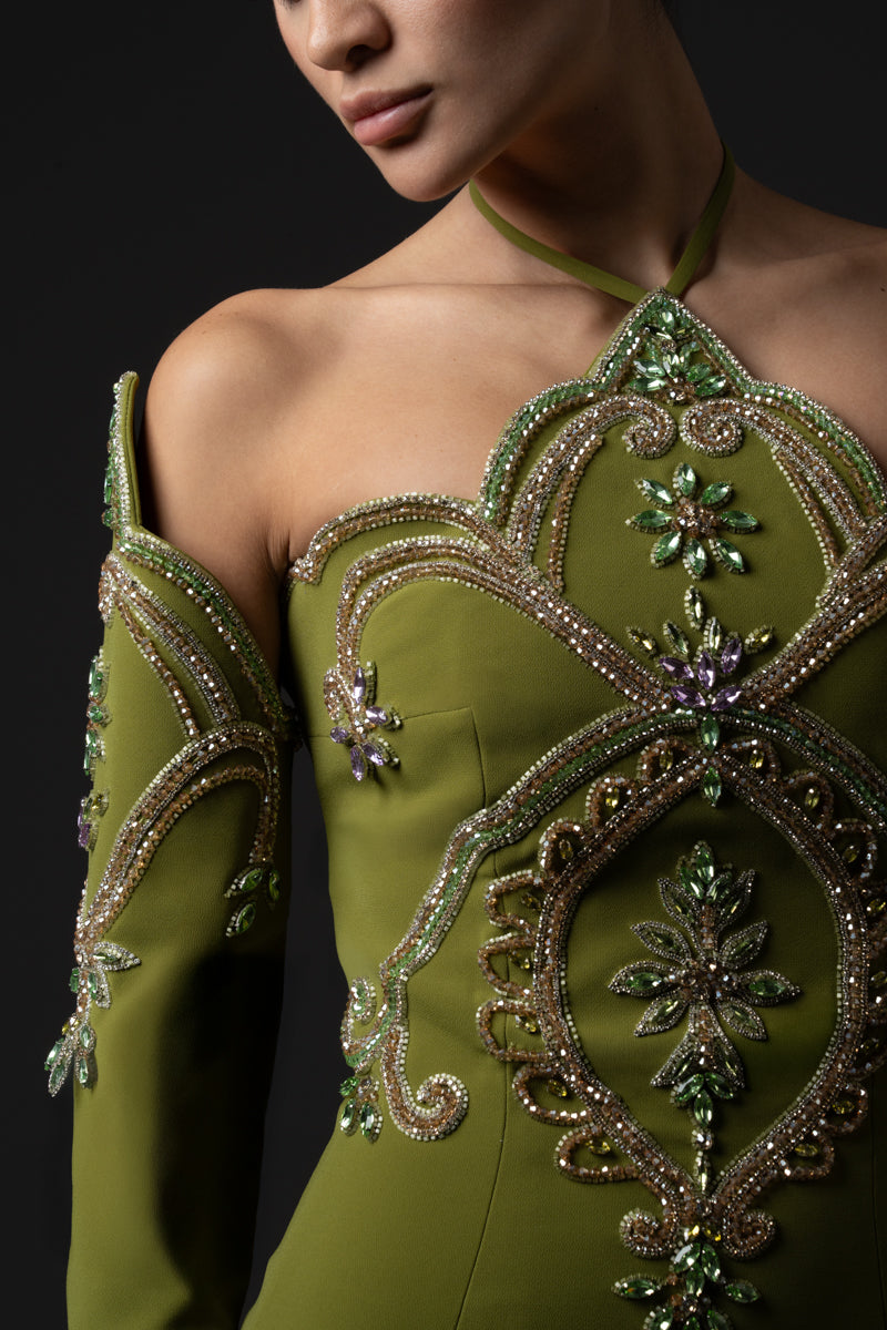 Fitted gown featuring a pointed neckline and matching sleeves