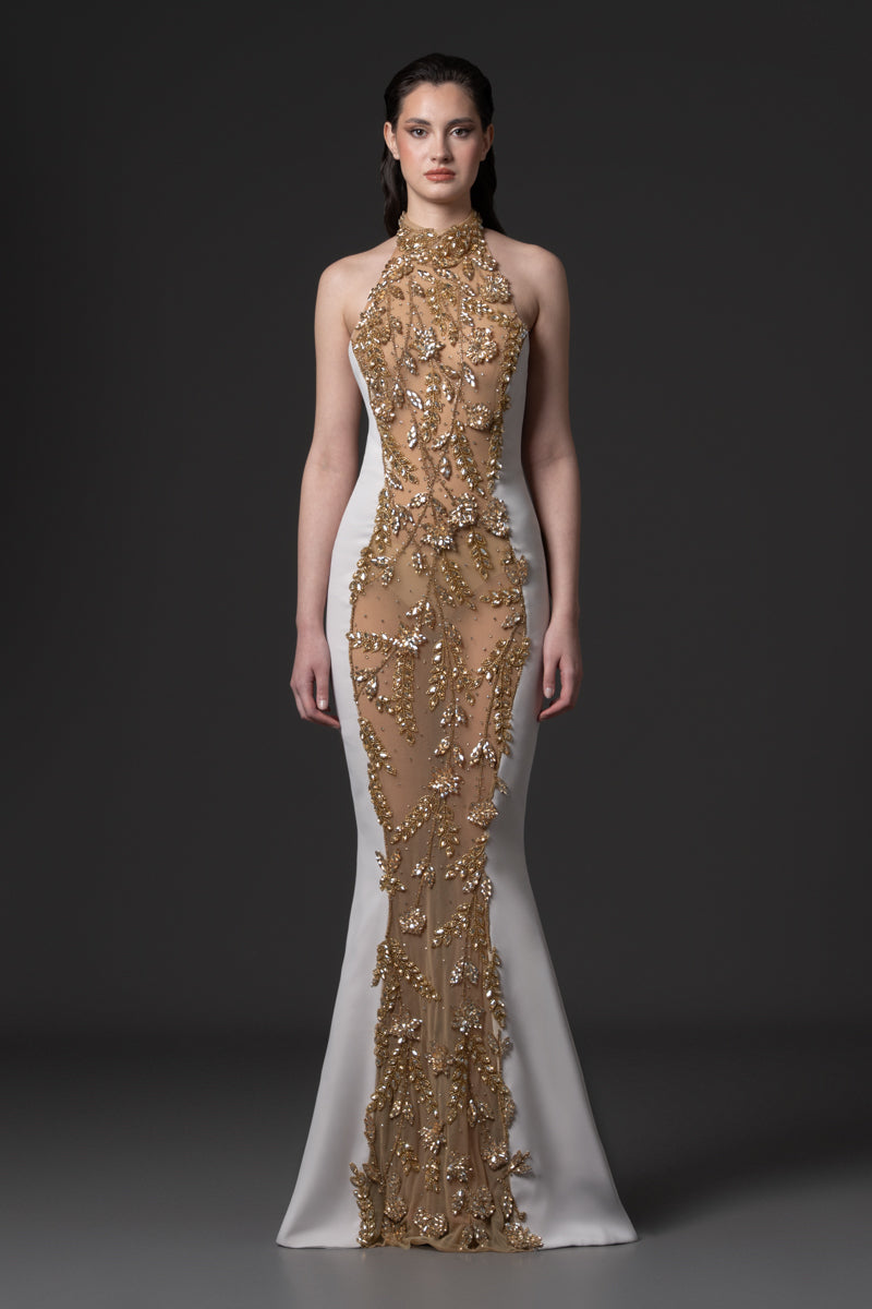 A fitted halter neck crêpe gown embellished with stones in the middle