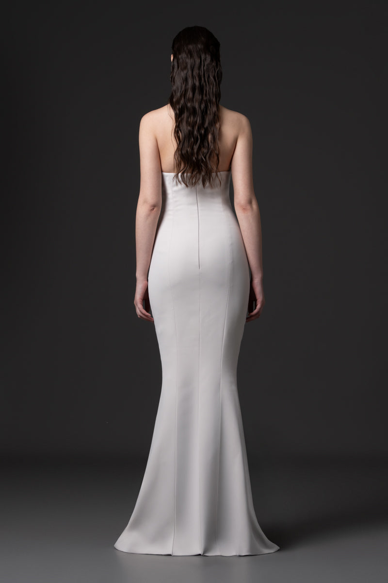 A fitted halter neck crêpe gown embellished with stones in the middle