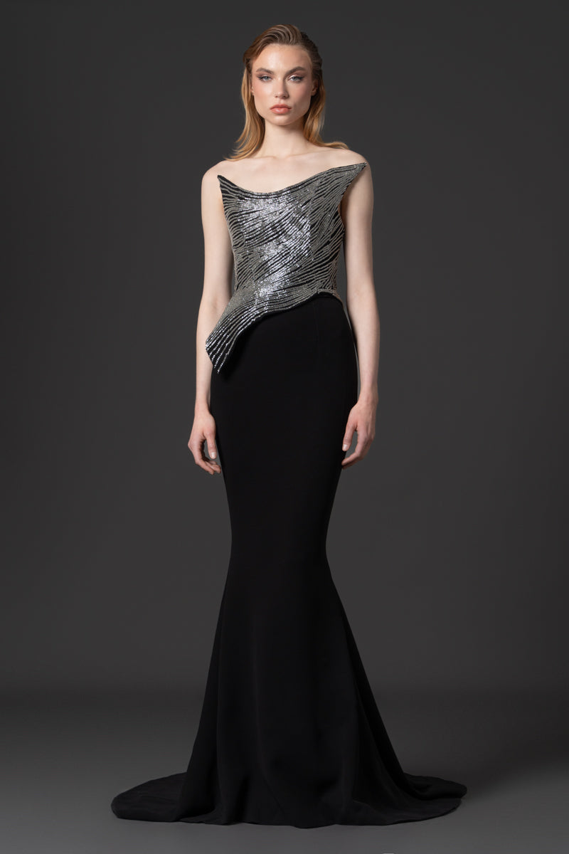 A fitted mermaid crêpe gown designed with a beaded pointed corset