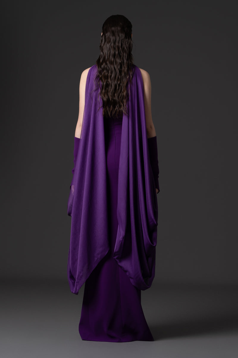 A halter-neck crêpe gown with beaded borders and draped chiffon connected
to the sleeves