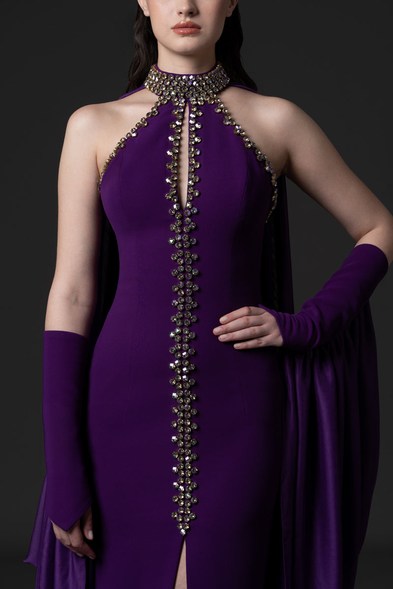 A halter-neck crêpe gown with beaded borders and draped chiffon connected
to the sleeves
