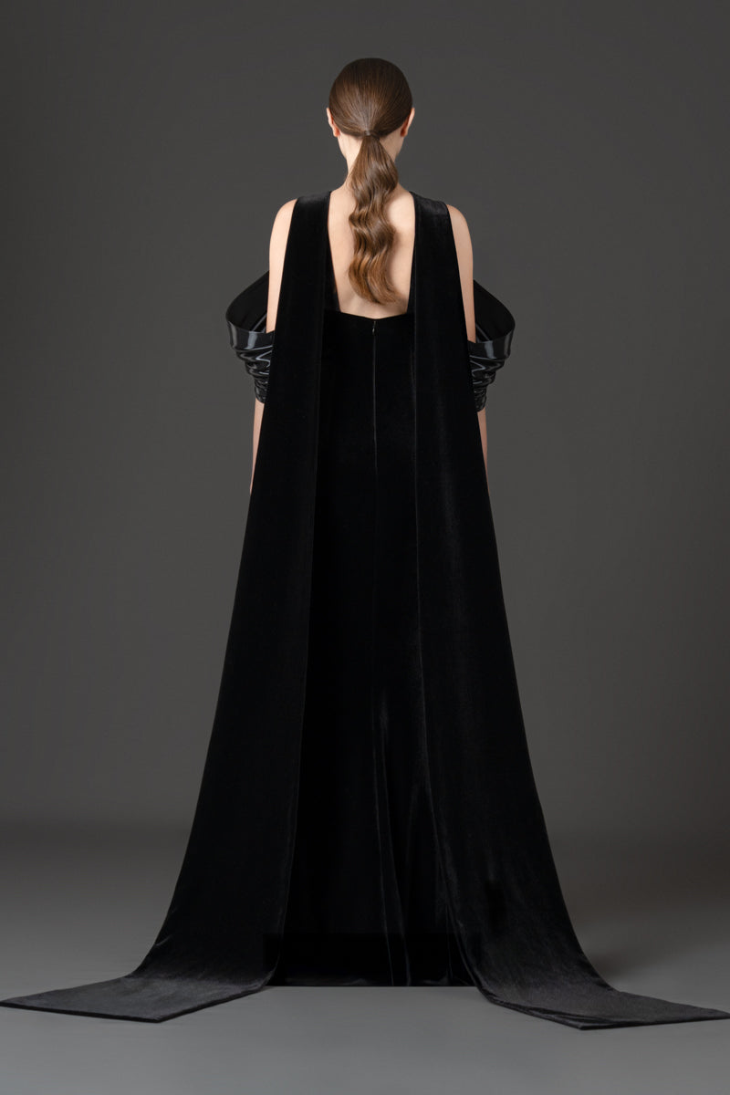 Halter-neck fitted velvet dress featuring a liquid gazar drape