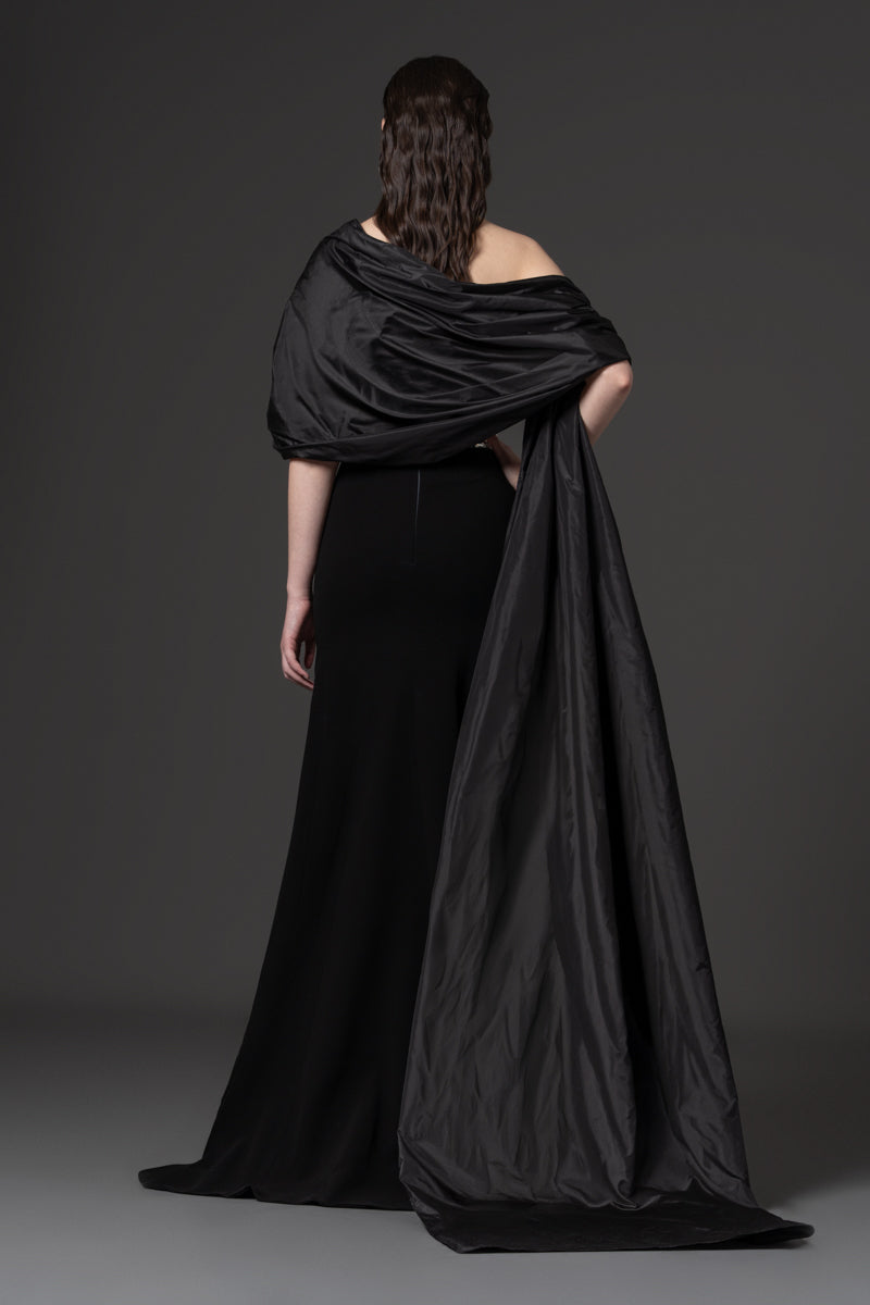 A strapless crepe gown with an elegant off-the-shoulder taffeta drape and baguette stones at the waist