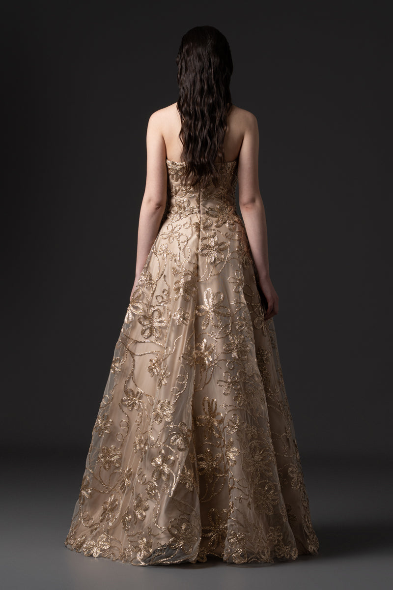 A strapless raffia-embroidered A-line gown with crystal stones on the bodice