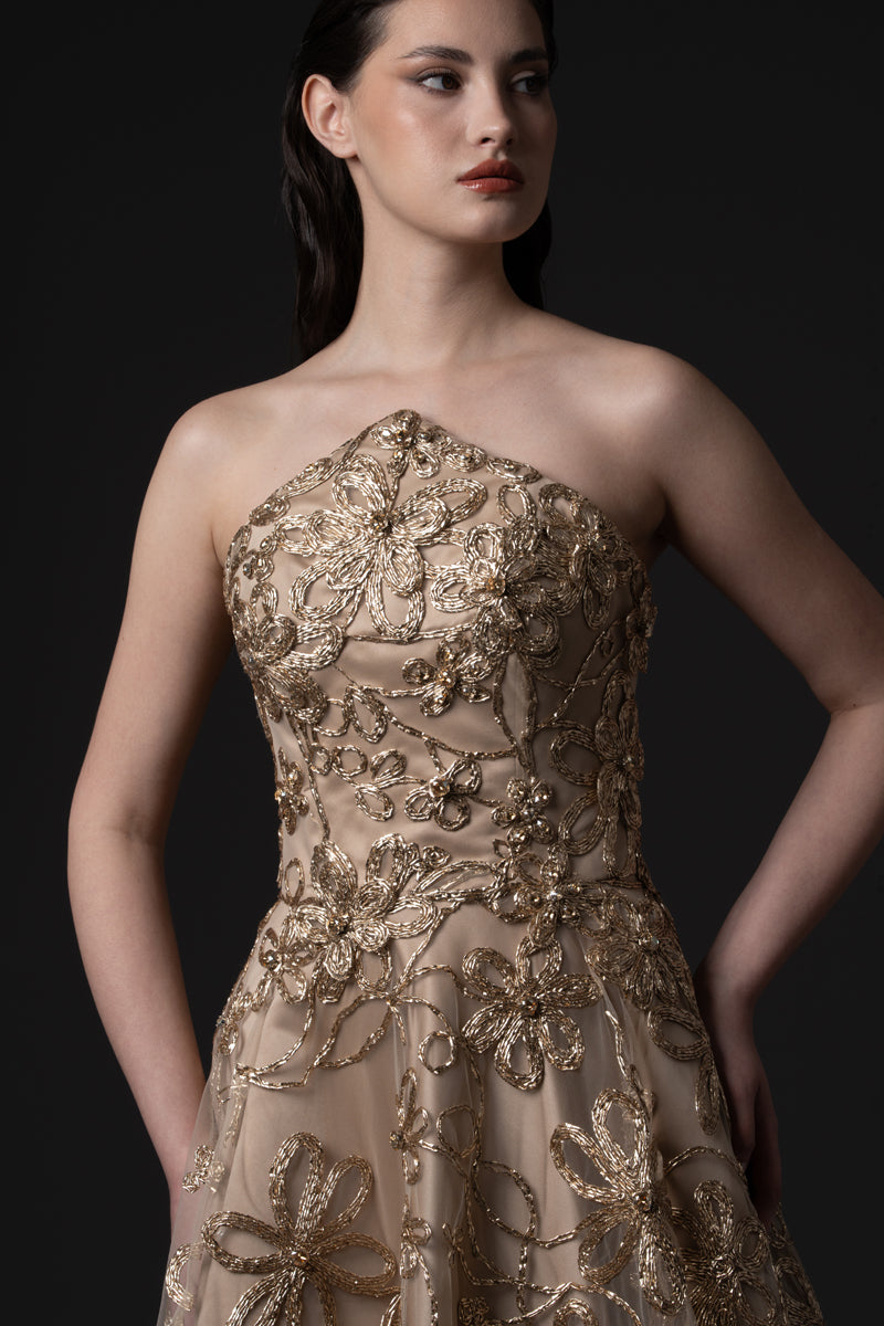 A strapless raffia-embroidered A-line gown with crystal stones on the bodice