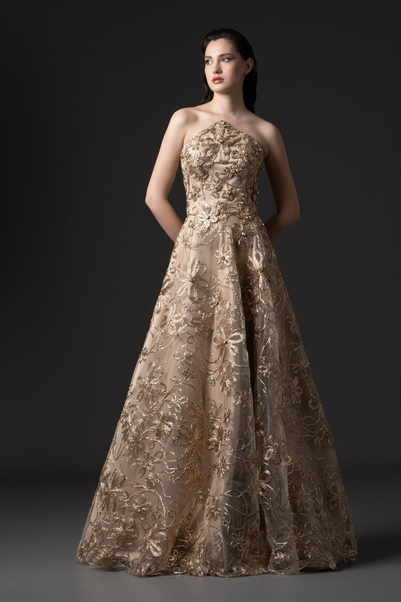 A strapless raffia-embroidered A-line gown with crystal stones on the bodice
