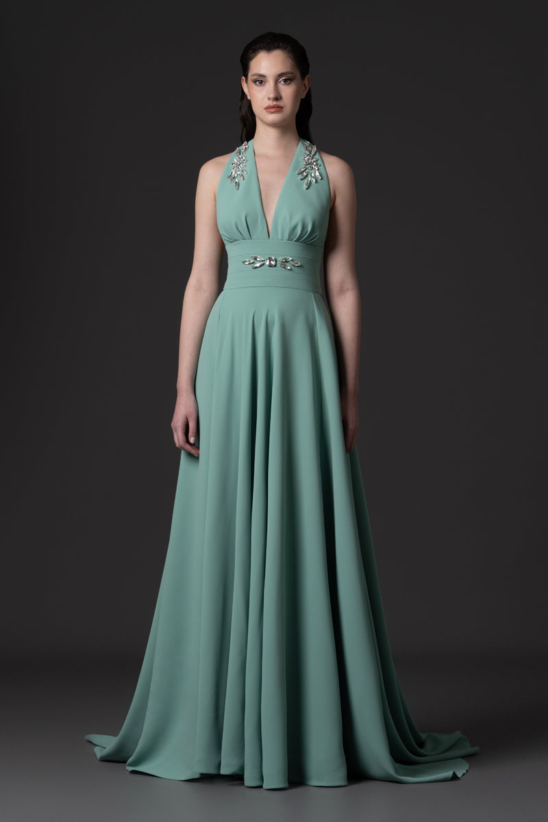 An A-line dress with deep V-neckline embellished with crystal
stones on straps and waist