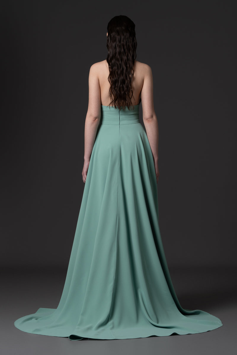 An A-line dress with deep V-neckline embellished with crystal
stones on straps and waist