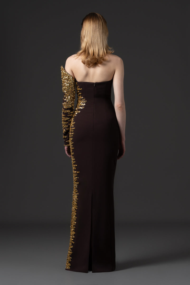 An asymmetrical fitted dress beaded with sequins along one side