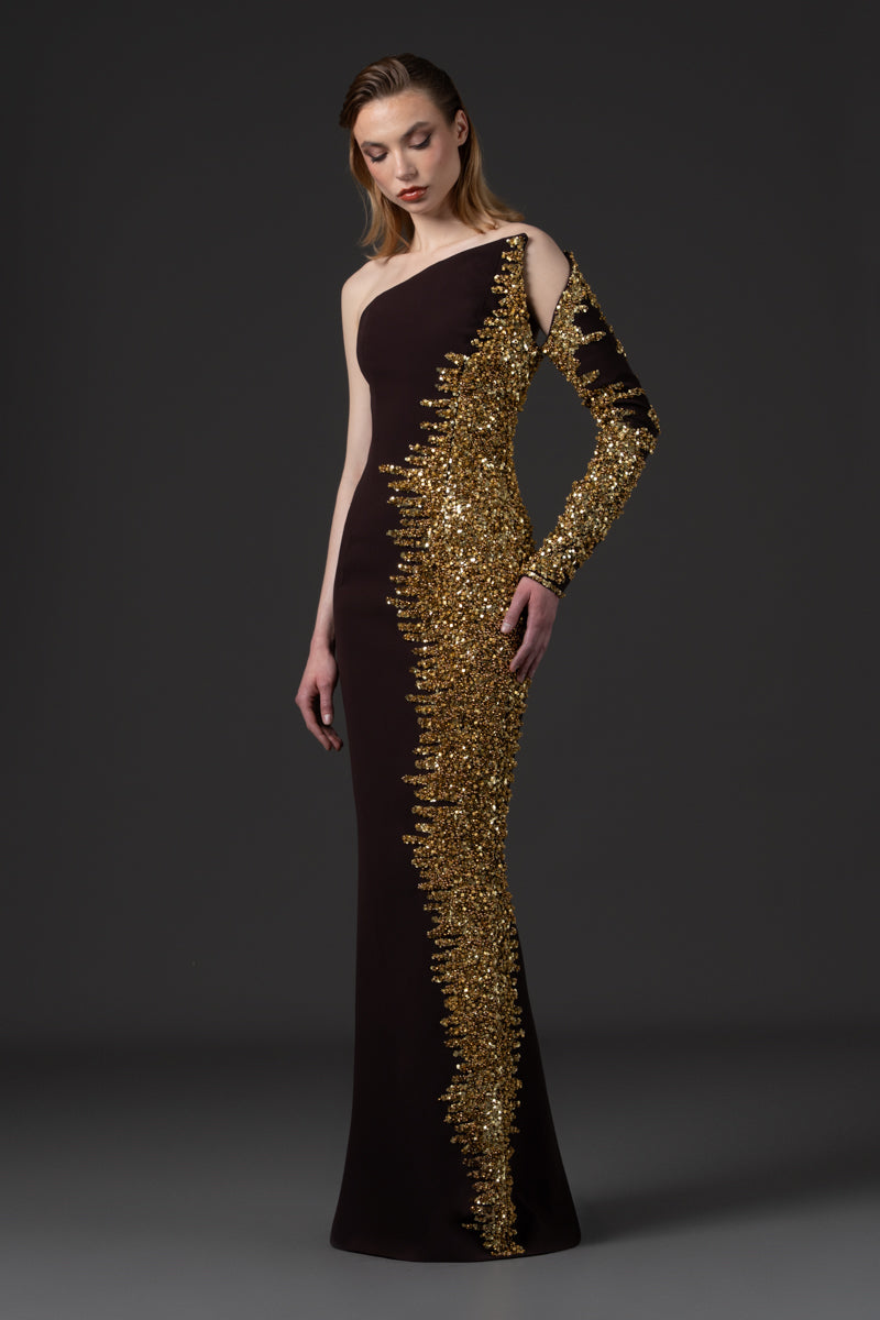 An asymmetrical fitted dress beaded with sequins along one side