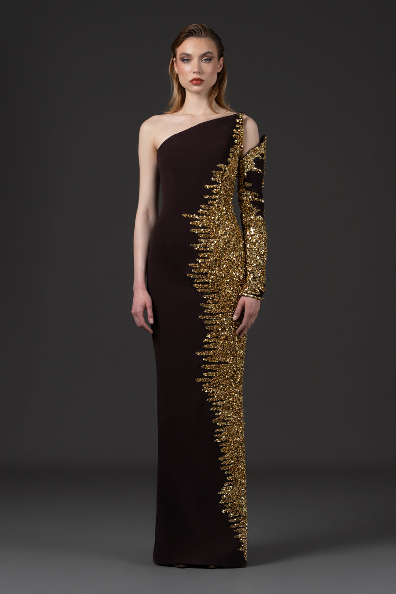 An asymmetrical fitted dress beaded with sequins along one side