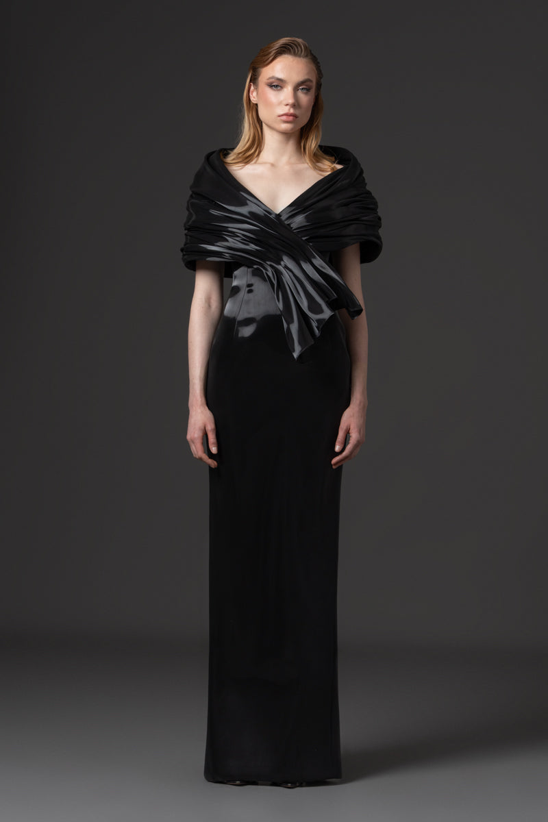 An off-shoulder liquid gazar dress with sculptural draping on the bust