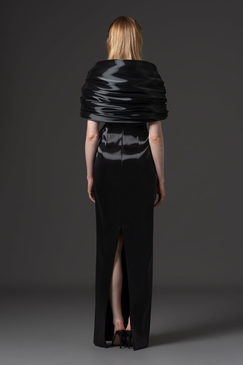 An off-shoulder liquid gazar dress with sculptural draping on the bust