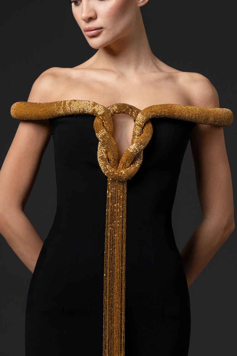 Off the shoulder crêpe gown featuring an embroidered neckline with fringes