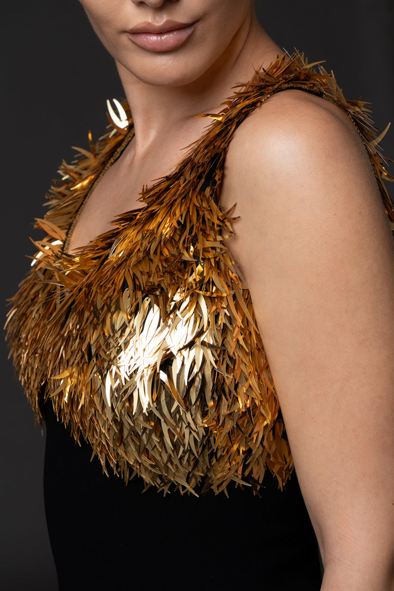 Black crêpe dress, featuring gold spike embroidery and a side slit.