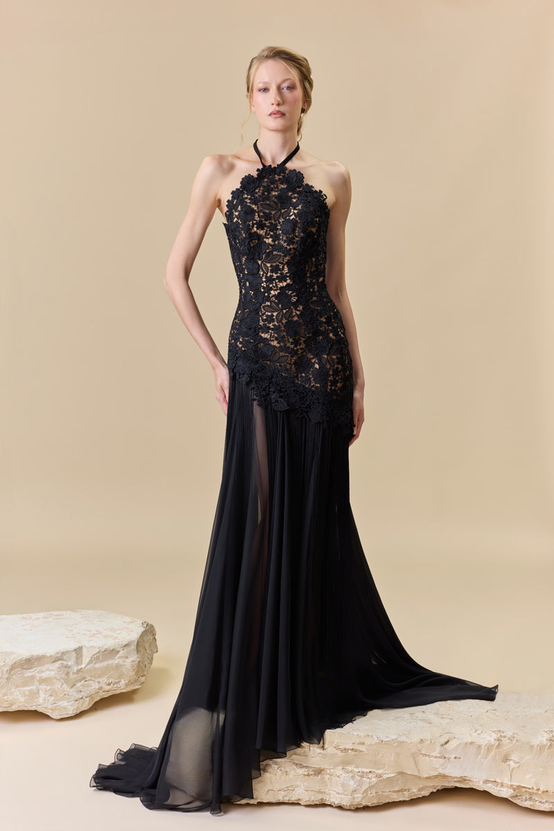 A guipure halter-neck gown with a fitted bodice and a chiffon skirt with silk fringes on it.
