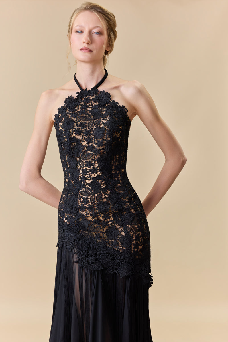 A guipure halter-neck gown with a fitted bodice and a chiffon skirt with silk fringes on it.