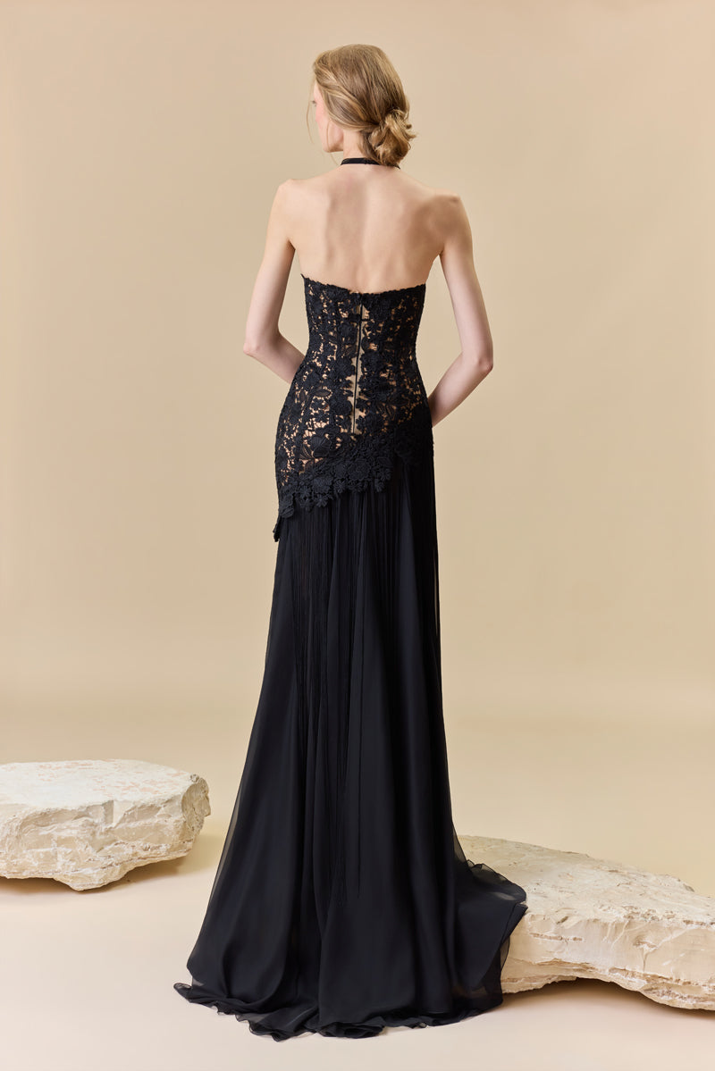 A guipure halter-neck gown with a fitted bodice and a chiffon skirt with silk fringes on it.
