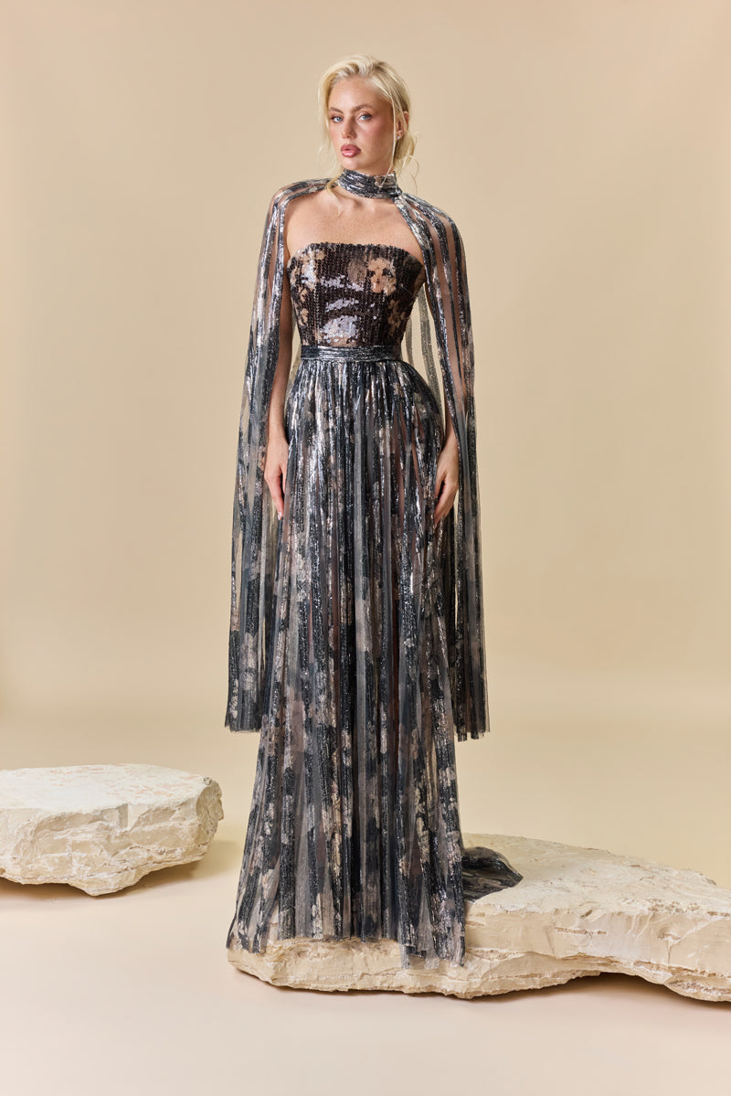 A strapless printed sequins A-line dress with a flowing cape.