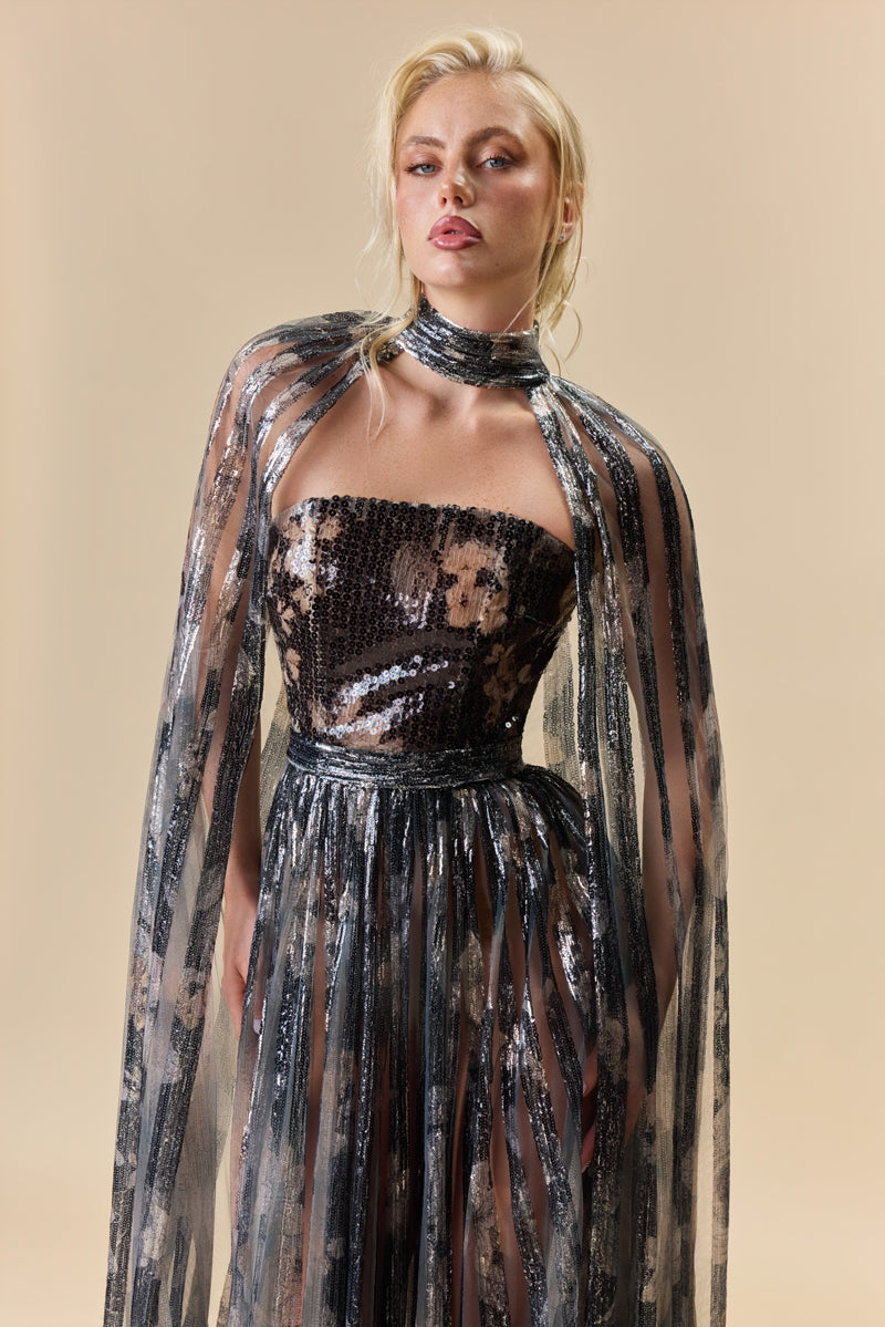 A strapless printed sequins A-line dress with a flowing cape.