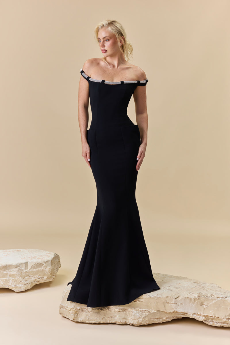 An off-shoulder crêpe fitted dress with pockets and a beaded chord detail along the neckline.