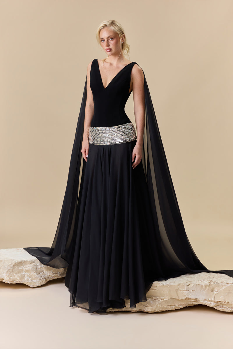A deep V-neck dress with a crêpe fitted bodice, chiffon skirt and baguette stones beading at the hips.