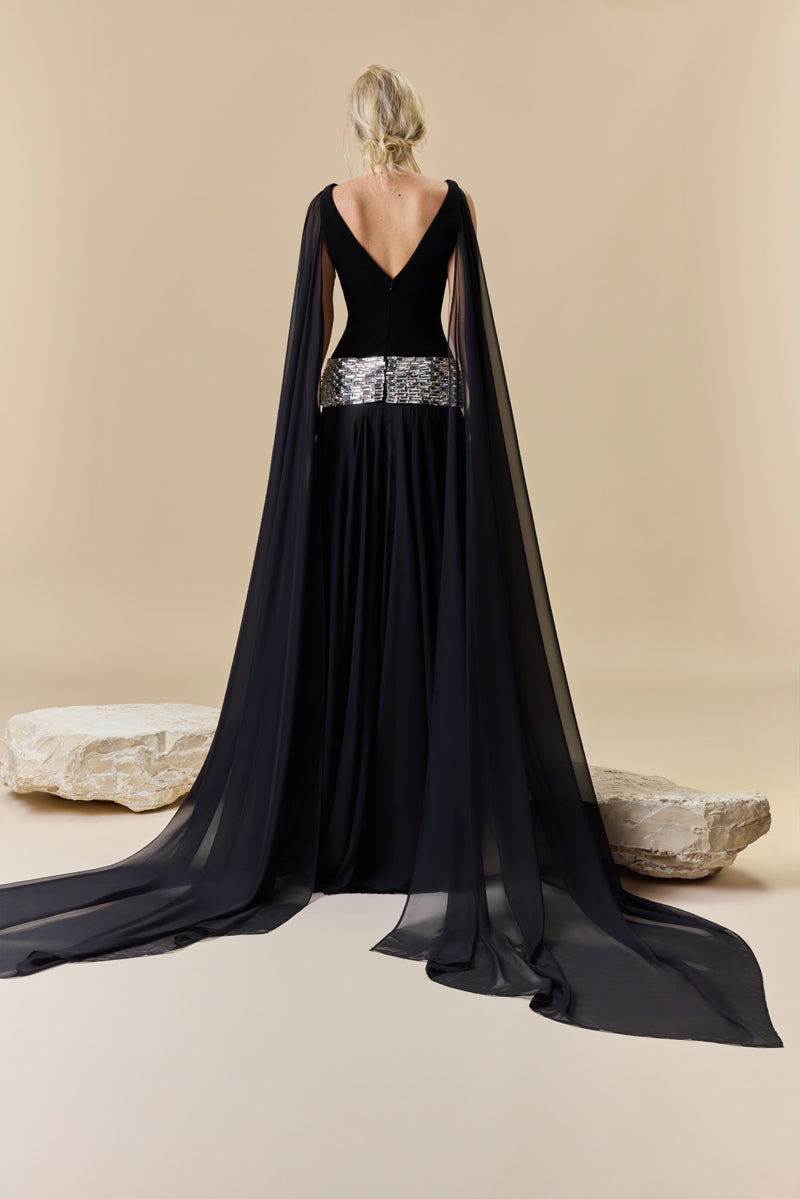 A deep V-neck dress with a crêpe fitted bodice, chiffon skirt and baguette stones beading at the hips.