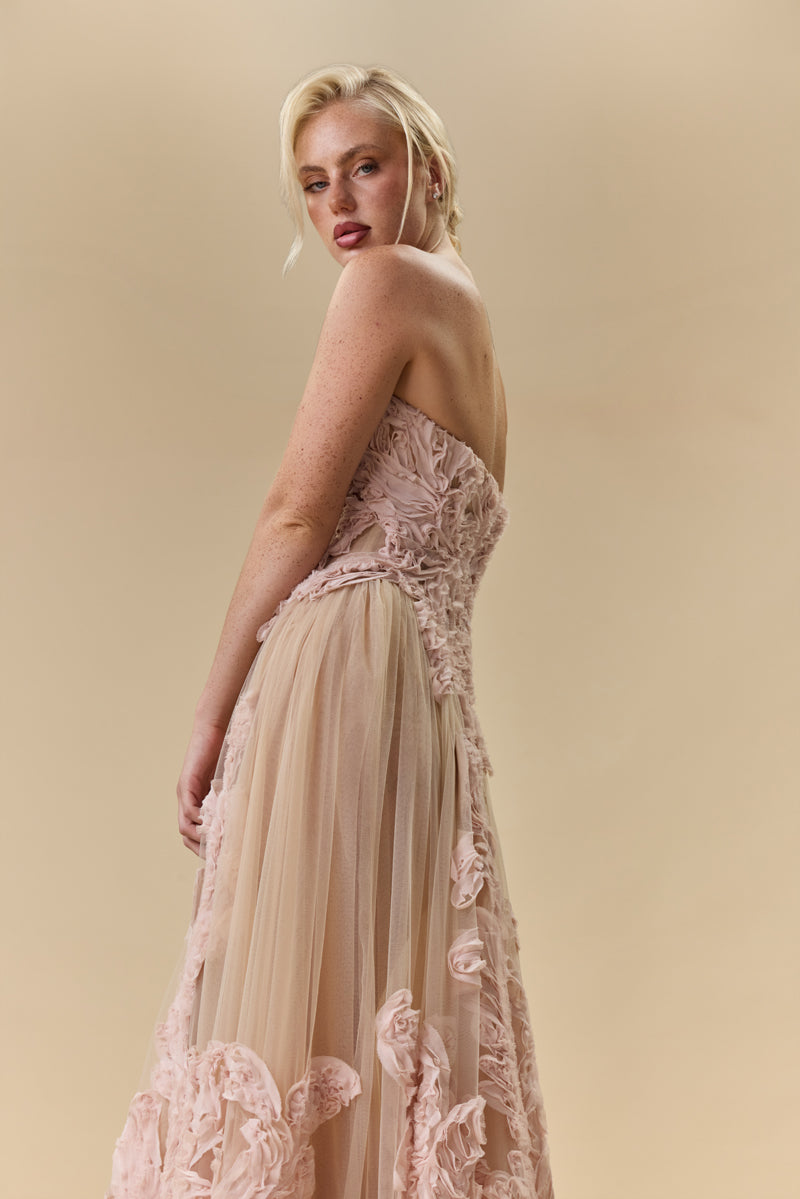 A strapless sculpted strapless corset embellished with intricate crepe georgette trims flowing into a sheer gathered tulle skirt.