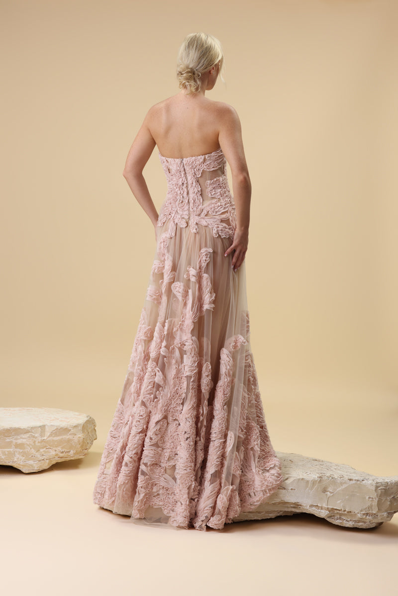 A strapless sculpted strapless corset embellished with intricate crepe georgette trims flowing into a sheer gathered tulle skirt.
